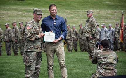 An Iowa civilian is awarded during Command Retreat just after the 88th Regional Support Command dedicated a plaque at Camp Dodge, Iowa on May 25, in honor of the 88th Infantry Division's beginning there in 1917. During the Command Retreat, Airmen, Soldiers, and Civilians are recognized by Maj. Gen. Timothy Orr, Adjutant General of the Iowa National Guard, for their contributions to the Guard and their communities, state and nation.