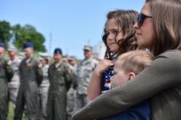 An family attends Command Retreat and watches while the 88th Regional Support Command dedicates a plaque at Camp Dodge, Iowa on May 25, in honor of the 88th Infantry Division's beginning there in 1917. During the Command Retreat, Airmen, Soldiers, and Civilians are recognized by Maj. Gen. Timothy Orr, Adjutant General of the Iowa National Guard, for their contributions to the Guard and their communities, state and nation.