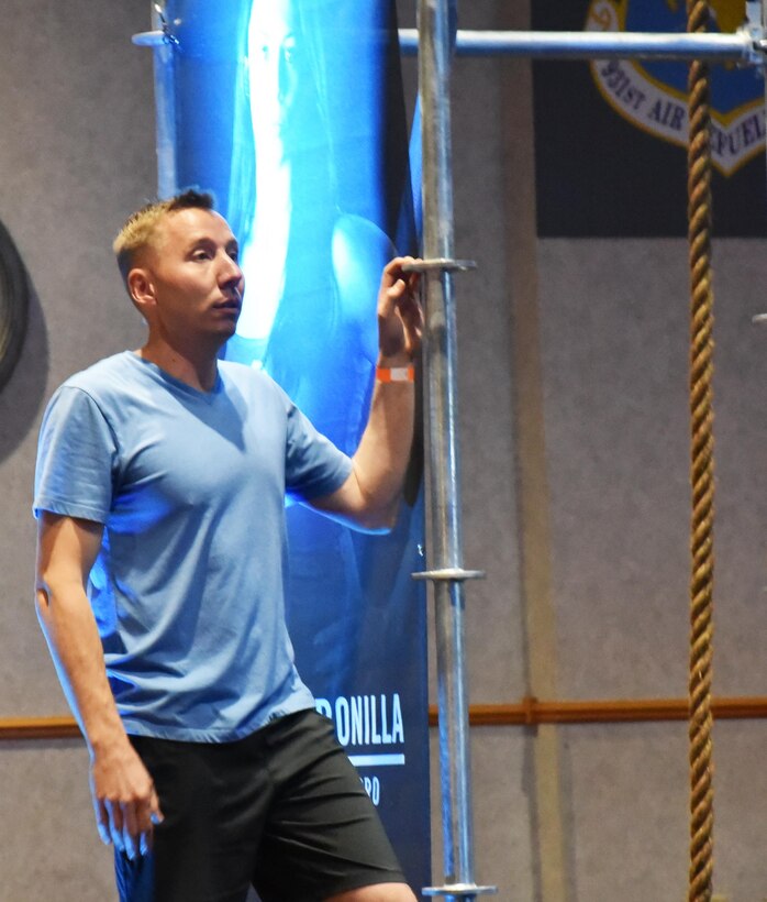 Maj. Brian Doom, 931st Operations Support Squadron Chief of Current Operations, prepares to climb on the obstacle course as part of the Alpha Warrior Air Force Tour, May 27, 2016, at McConnell Air Force Base, Kan.  The main event was a competition featuring a timed obstacle course set up in the Dole Center Ballroom.  The layout was similar to obstacle courses featured on “American Ninja Warrior,” which Doom competed for last year.  (U.S. Air Force photo by Tech. Sgt. Abigail Klein)