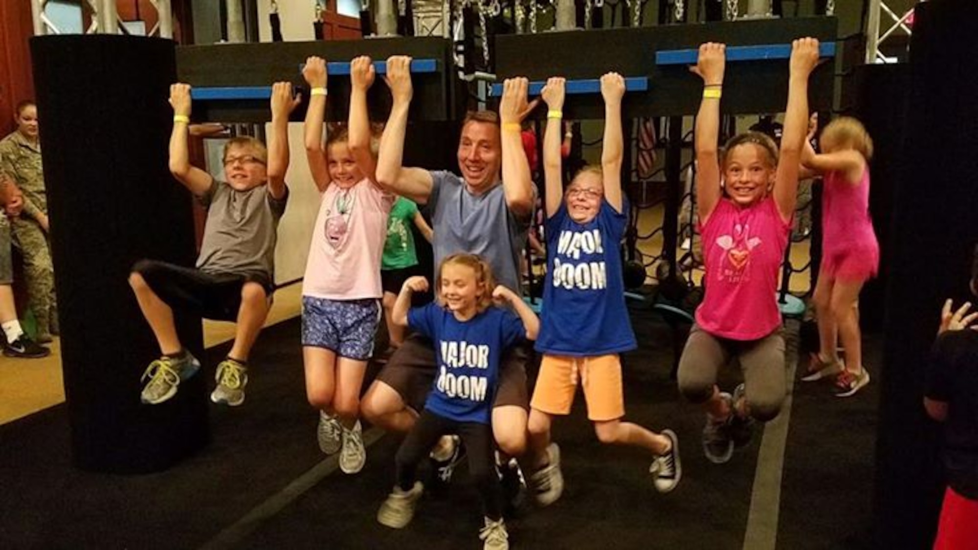 Maj. Brian Doom, 931st Operations Support Squadron Chief of Current Operations, poses with his children before competing in the Alpha Warrior Tour May 27, 2017, atMcConnell Air Force Base, Kan. The Alpha Warrior Air Force Tour recently visited Team McConnell and one Citizen Airmen and former “American Ninja Warrior” competitor decided it was another opportunity to take his fitness to the next level. (Courtesy photo)