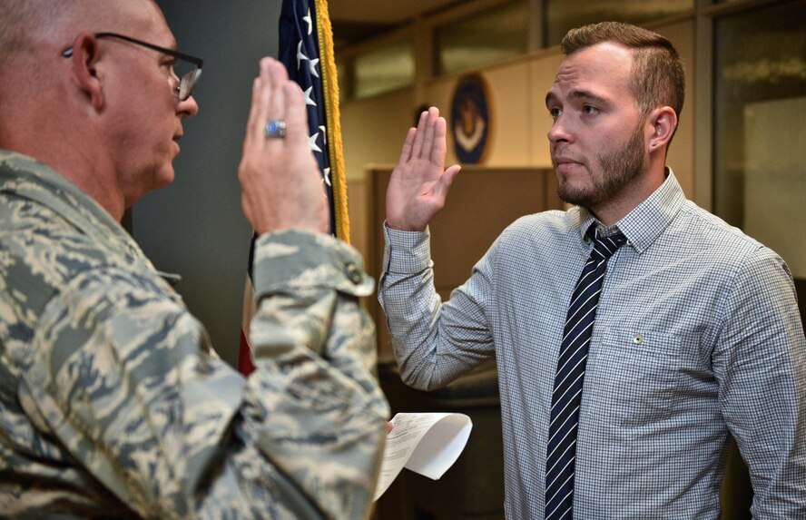 Nathaniel Syrcle takes the oath of enlistment, given by Lt. Col. Stan Paregien, 932nd Airlift Wing public affairs officer, May 31, 2017, Scott Air Force Base Illinois. Sycrle is fulfilling a childhood dream to become a firefighter and the Air Force Reserve is helping him to achieve that dream.  "I'm ready to be that person", said Syrcle about why he wanted to join the military.  (U.S. Air Force photo by Christopher Parr)