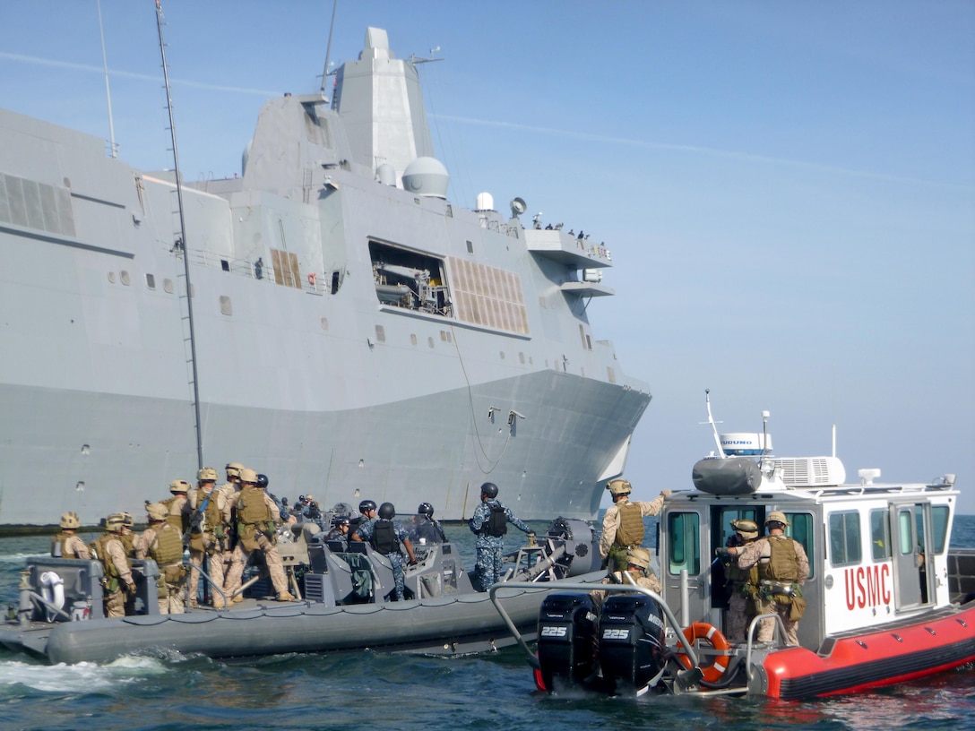 Marines from 2nd Reconnaissance Battalion conduct visit, board, search and seizure training alongside the USS San Antonio (LPD-17 off the coast of Virginia Beach, Va., while an Open Water Safety Craft floats nearby. The OWSC has been in service since 2006, and is used as an emergency vessel during waterborne training operations. Marine Corps Systems Command is working with Marine Corps Logistics Command and the National Marine Center to refurbish 28 boats in the Corps inventory. (U.S. Marine Corps photo by Jake Feeney)