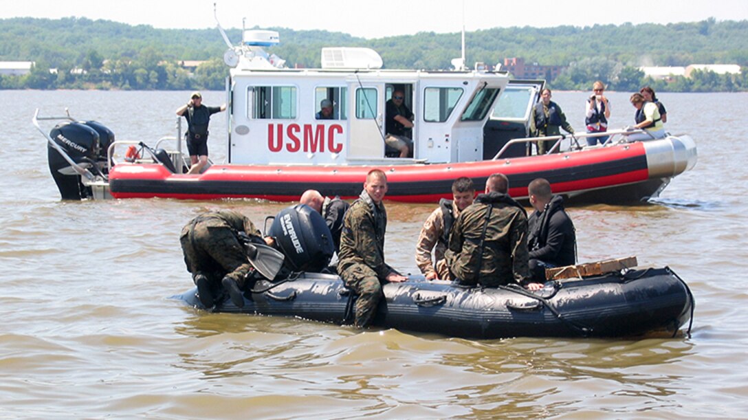 Marines from Marine Corps Systems Command conduct helocasting of the Zodiac F470 near Quantico, Va., while an Open Water Safety Craft floats nearby. The OWSC has been in service since 2006, and is used as an emergency vessel during waterborne training operations. Marine Corps Systems Command is working with Marine Corps Logistics Command and the National Marine Center to refurbish 28 boats in the Corps inventory. (U.S. Marine Corps photo by Jake Feeney)