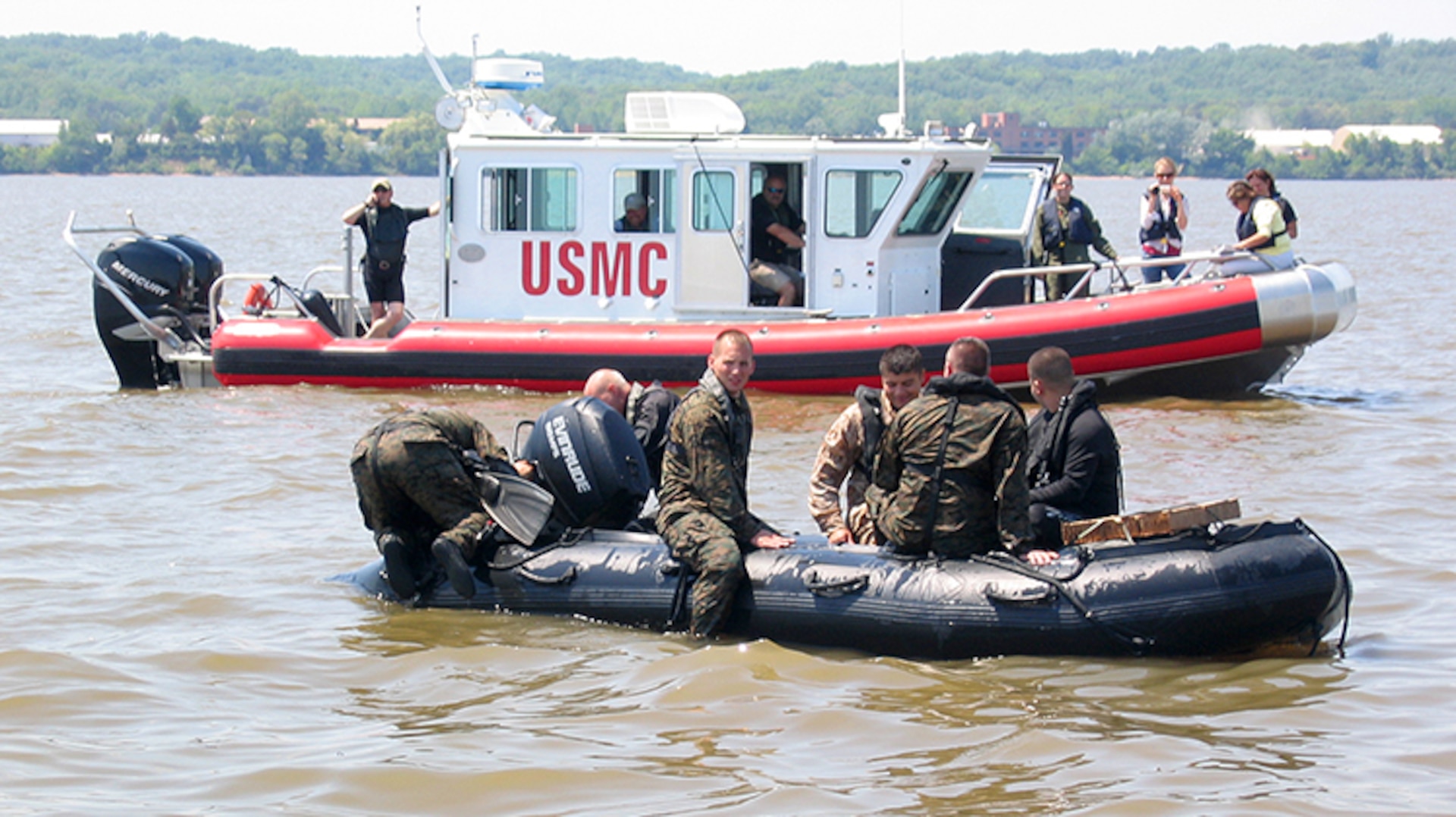 Marines from Marine Corps Systems Command conduct helocasting of the Zodiac F470 near Quantico, Va., while an Open Water Safety Craft floats nearby. The OWSC has been in service since 2006, and is used as an emergency vessel during waterborne training operations. Marine Corps Systems Command is working with Marine Corps Logistics Command and the National Marine Center to refurbish 28 boats in the Corps inventory. (U.S. Marine Corps photo by Jake Feeney)