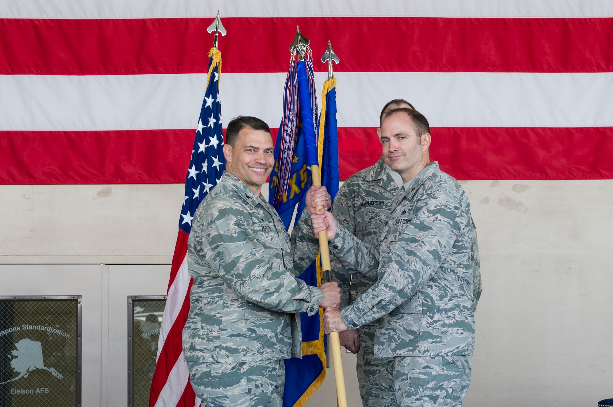 U.S. Air Force Col. Gregory Hutson, the 354th Maintenance Group commander, passes the 354th Maintenance Squadron, MXS guidon to Maj. Daniel Kline, the new 354th MXS commander, May 30, 2017, at Eielson Air Force Base, Alaska. Kline, took command from Maj. Timothy Stokes, who will serve as the 361st Training Squadron commander at Sheppard Air Force Base, Texas. (U.S. Air Force photo by Airman 1st Class Isaac Johnson)