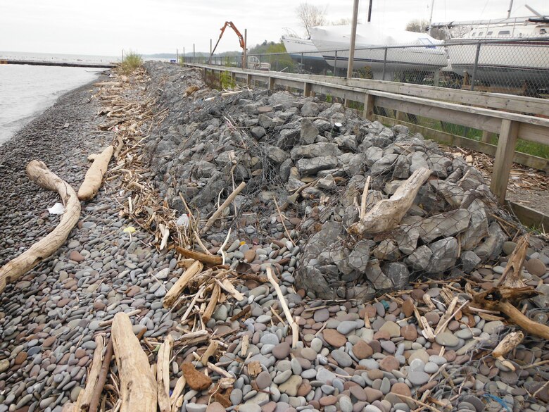 Facing east, the location is Lake Ontario shoreline, just west of the Olcott Harbor West Pier. Gabions were installed as part of Operation Foresight around 1973 or 1974. Photo was taken on May 12, 2017.   

