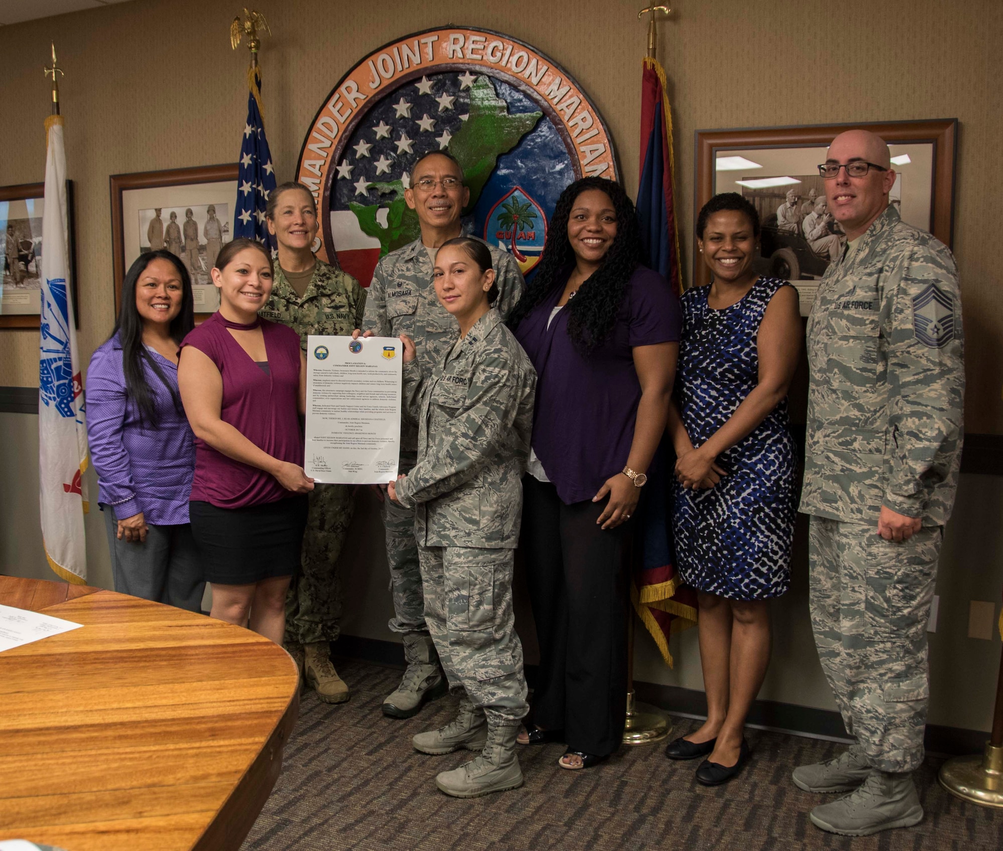 Members with the 36th Medical Group and Joint Region Marianas (JRM) kick off Domestic Violence Awareness month by signing a proclamation at JRM headquarters in Asan, Guam, Oct. 2, 2017. Domestic violence is an offense under the United States Code, the Uniform Code of Military Justice and state law. Regulations require military and Department of Defense officials to report any suspicion of family violence. This includes commanders, first sergeants, supervisors, medical personnel and military police. (U.S. Navy photo by JoAnna Delfin)