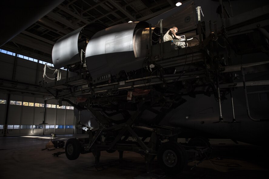 U.S. Air Force Senior Airman Cody Logan, 721st Aircraft Maintenance Squadron aerospace propulsion journeyman, begins to lower a damaged C-17 Globemaster III engine at a hangar on Ramstein Air Base, Germany, Oct. 27, 2017. The maintainers then wheeled the damaged engine away to place the new engine in its place. The engine swap took about 72 hours to complete. (U.S. Air Force photo by Senior Airman Devin Boyer)