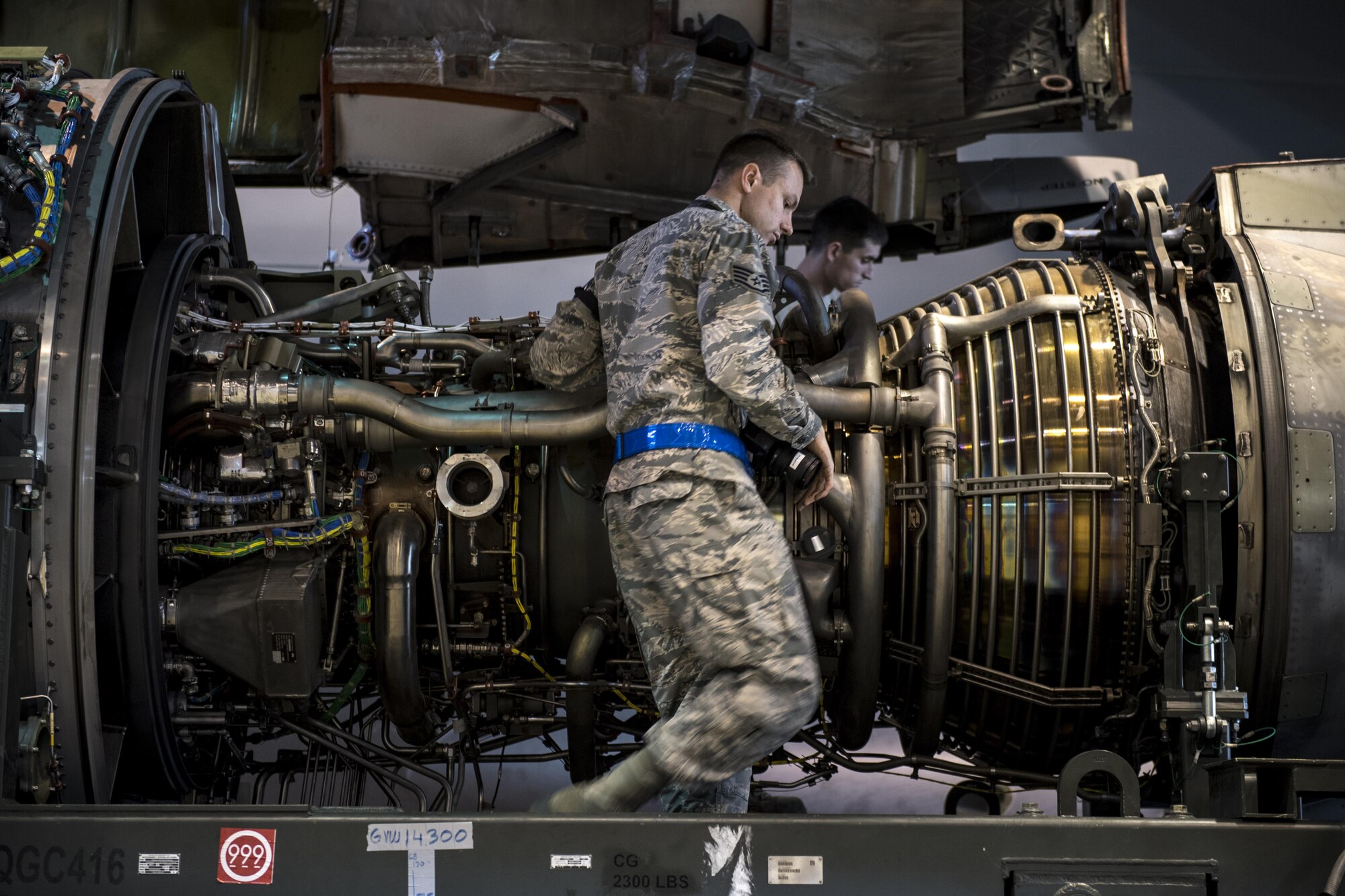 U.S. Air Force Staff Sgt. Kevin Baker, 721st Aircraft Maintenance Squadron quality assurance inspector, inspects the damaged engine of a C-17 Globemaster III at a hangar on Ramstein Air Base, Germany, Oct. 27, 2017. Senior Airman Taylor Corliss, 721st AMXS aerospace propulsion journeyman, right, and his colleagues removed the engine to replace it with an operable one. Baker ensured they completed the job accurately.  (U.S. Air Force photo by Senior Airman Devin Boyer)