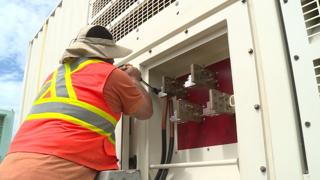 U.S. Army Corps of Engineers contractor Installs cables that run from the generator to the transformer. The generator was installed at the Barceloneta Water Treatment Plant which provides water to a large number of factories in the area. With power restored, factory workers will be able to return to work. (USACE Photo by Mike A. Glasch)