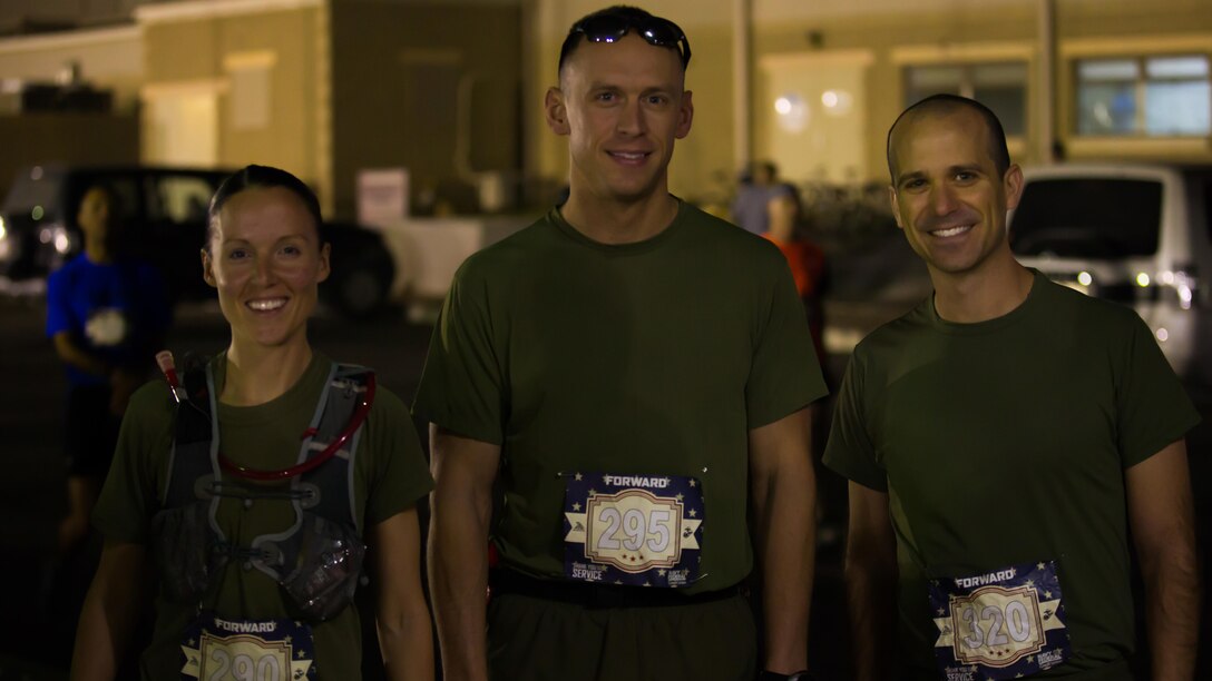 Service members deployed with Special Purpose Marine Air-Ground Task Force – Crisis Response – Central Command, (left to right) U.S. Marine Capt. Danielle Pozun, U.S. Marine Capt. Michael Nordin and LCDR Jeffrey Cook, pose for a photo at the beginning of the 42nd Marine Corps Marathon while in the Middle East Oct. 22, 2017. The Marine Corps Marathon is one of the largest marathons in the world and hosts the event in forward locations to allow service members outside the United States an opportunity to compete.