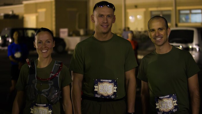 Service members deployed with Special Purpose Marine Air-Ground Task Force – Crisis Response – Central Command, (left to right) U.S. Marine Capt. Danielle Pozun, U.S. Marine Capt. Michael Nordin and LCDR Jeffrey Cook, pose for a photo at the beginning of the 42nd Marine Corps Marathon while in the Middle East Oct. 22, 2017. The Marine Corps Marathon is one of the largest marathons in the world and hosts the event in forward locations to allow service members outside the United States an opportunity to compete.