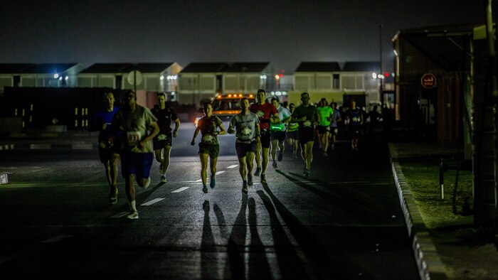 Captain Danielle Pozun (center left) a Marine deployed with Special Purpose Marine Air-Ground Task Force – Crisis Response – Central Command and a member of the Marine Corps Running Team, runs the 42nd Marine Corps Marathon Forward while in the Middle East Oct. 22, 2017. The Marine Corps Marathon is one of the largest marathons in the world and hosts the event in forward locations to allow service members outside the United States an opportunity to compete.