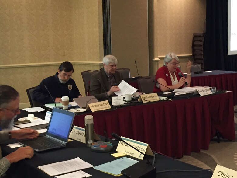 U.S. Fish and Wildlife Service representative, U.S. Army Corps of Engineers representative, and MRRIC chair seated at a table.