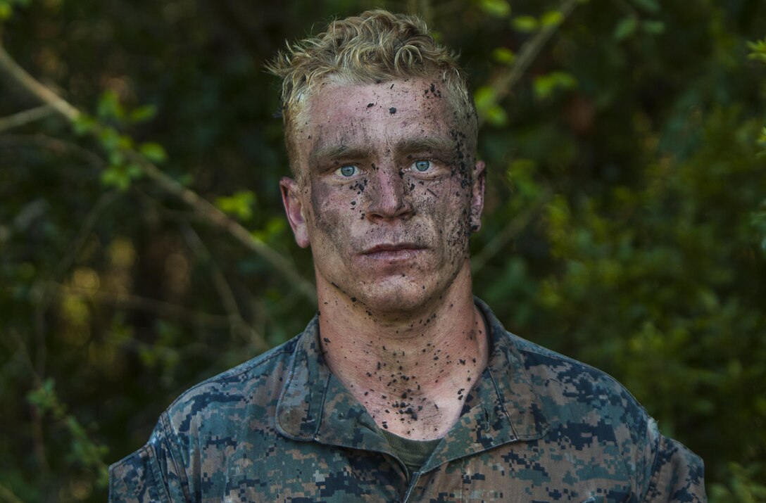 U.S. Marine Corps Cpl. Alois Scott, a machine gunner with the Battalion Landing Team 2nd Battalion, 6th Marine Regiment, 26th Marine Expeditionary Unit (MEU), stands cover in mud and debris after completing the final event of a Martial Arts Instructor Course (MAIC) at Marine Corps Base Camp Lejeune, N.C., Oct. 26, 2017.