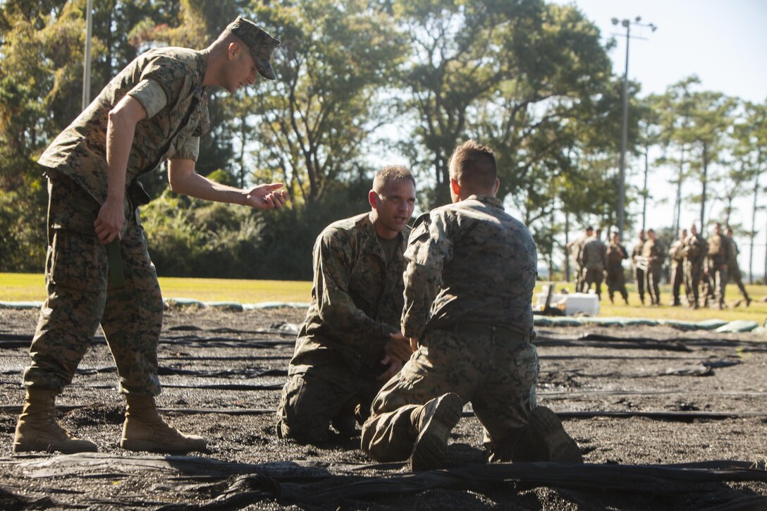 U.S. Marine Corps Lt. Col. Marcus Mainz, the battalion commander of Battalion Landing Team 2nd Battalion, 6th Marine Regiment, 26th Marine Expeditionary Unit (MEU), prepares to ground fight against Cpl. Devon Marden, an infantry Marine also with BLT 2/6, during a Martial Arts Instructor Course (MAIC) at Marine Corps Base Camp Lejeune, N.C., Oct. 26, 2017.