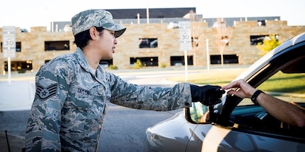 Staff Sgt. Mellissa Taylor, 559th Trainee Health Squadron optometry noncommissioned officer in charge, checks an ID at the Highway 90 gate while performing security forces augmentee duty Oct. 23 at Joint Base San Antonio-Lackland. The Highway 90 gate provides easy and convenient access for patients to quickly access care and facilities.