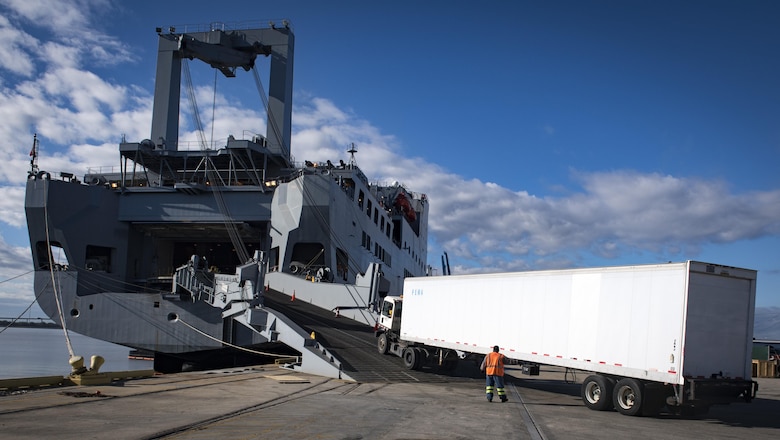 A longshoreman guides a truck carrying cargo onto the USNS Brittin (T-AKR-305) Oct. 29, 2017, at Joint Base Charleston-Weapons Station, S.C.