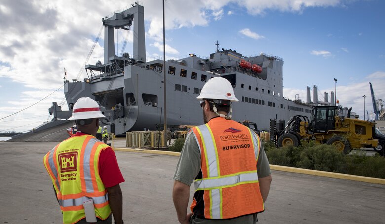 Dennis Davis, left, U.S. Army Corps of Engineers, Charleston District transportation management specialist and Jason Metts, right, Cooper Ports America International Longshoremen's Association superintendent, look on as the USNS Brittin (T-AKR-305) with 855 pieces of equipment Oct. 28, 2017, at Joint Base Charleston-Weapons Station, S.C.