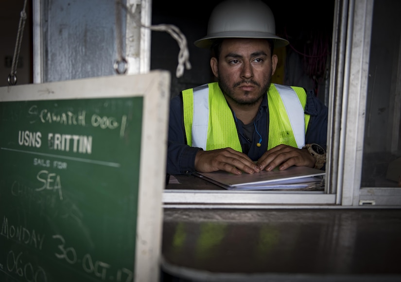 Jose Argueta, USNS Brittin (T-AKR-305) able seaman stands gangway watch during the ship's onloading at the Joint Base Charleston Naval Weapons Station Oct. 28, 2017.