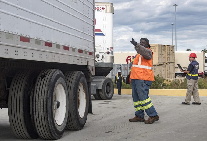 Longshoremen directs a truck onto the USNS Brittin (T-AKR-305) Oct. 29, 2017, at Joint Base Charleston-Weapons Station, S.C.