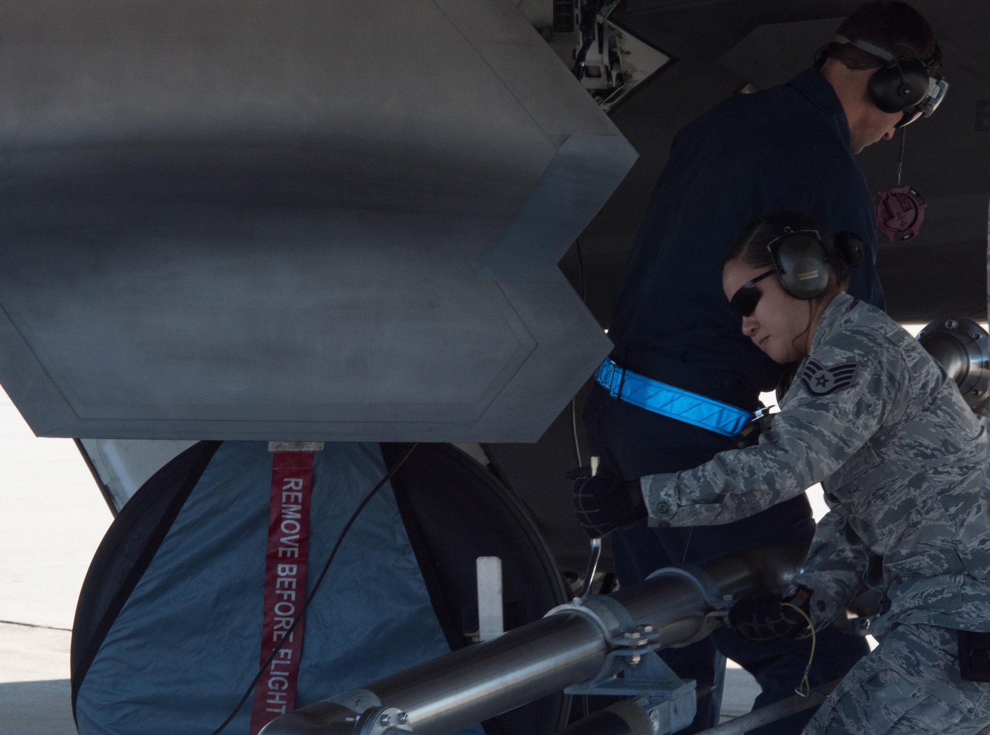 U.S. Air Force Staff Sgt. Maryann Tran, 733rd Logistics Readiness Squadron fuels distribution supervisor, assists in attaching a pantogragh refueling system to a 1st Fighter Wing F-22 Raptor during hot pit refueling at Joint Base Langley-Eustis, Va., Oct. 31, 2017.