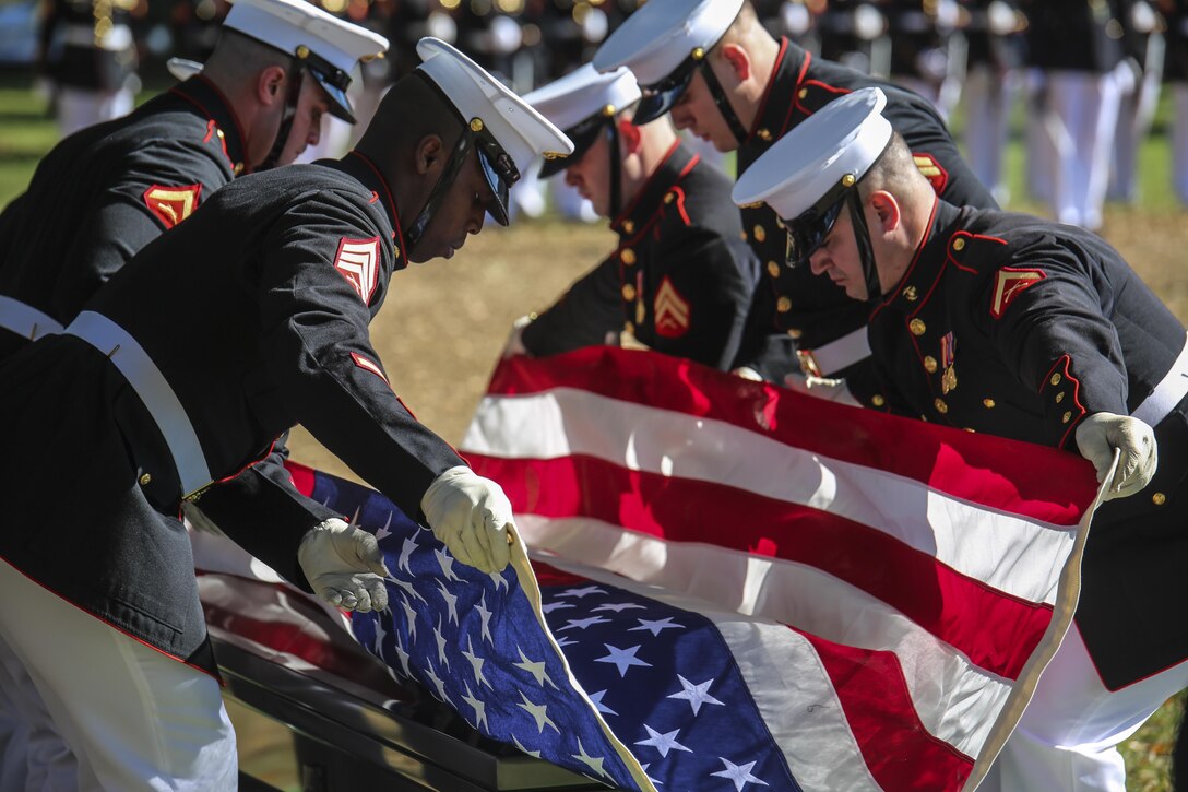 U.S. Marine Corps Body Bearers with Bravo Company, Marine Barracks Washington D.C., fold the National Ensign during a full honors funeral for Maj. Gen. Terrence R. Murray at Arlington National Cemetery, Arlington, Va., Oct. 31, 2017. Marine Barracks Washington is home to the Marines who provide support for all Marine Corps funerals and many high-ranking government officials’ funerals within the National Capitol Region. (Official U.S. Marine Corps photo by Cpl. Damon Mclean/Released)
