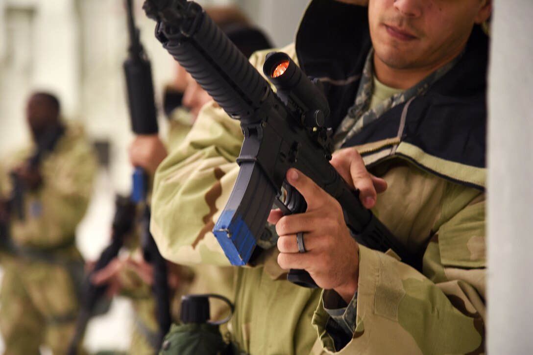 An airman checks his M-4 carbine rifle.