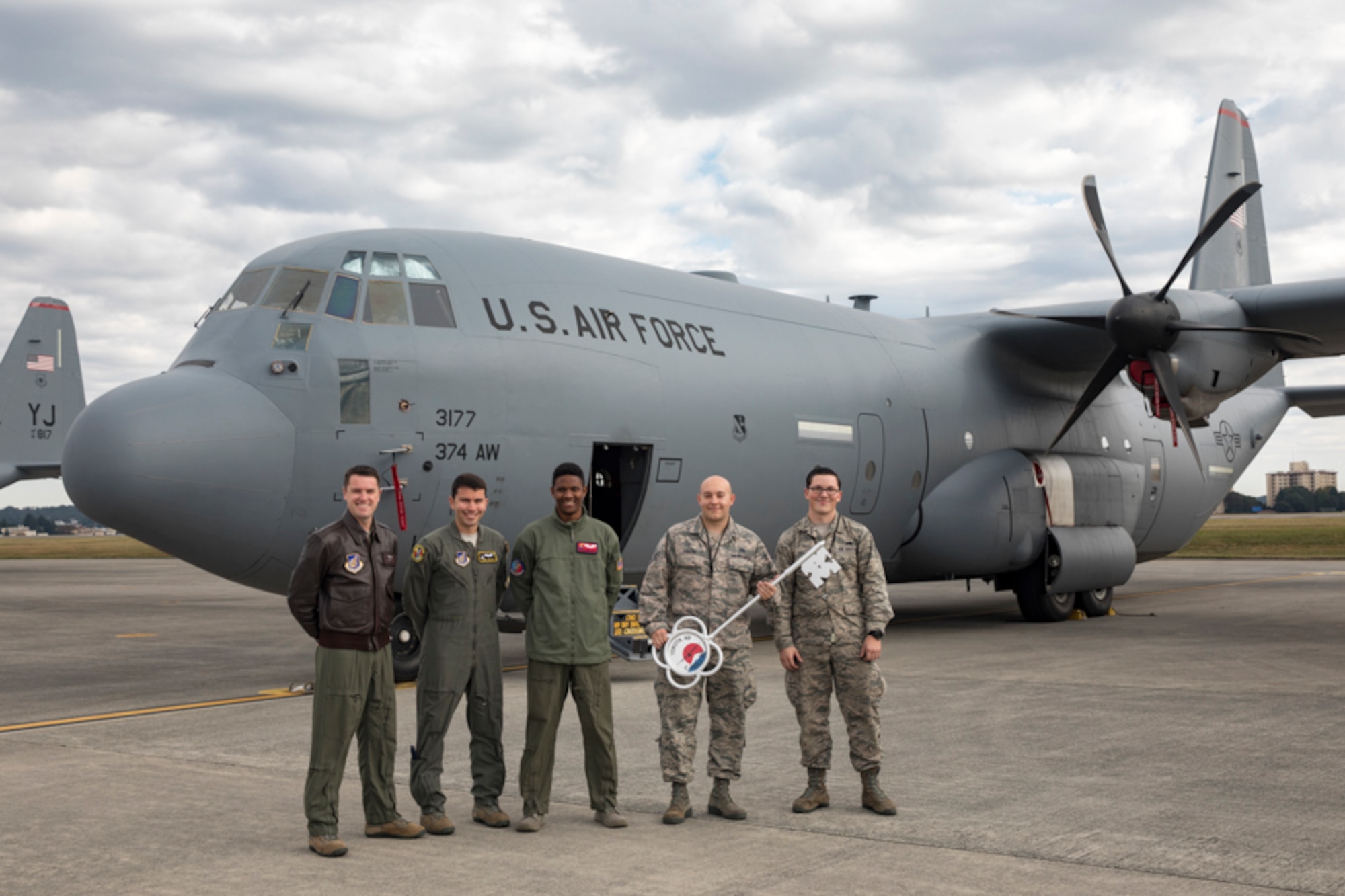 Members of the C-130J delivery team pose for a photo in front of a C-130J Super Hercules at Yokota Air Base, Japan, Oct. 31, 2107. This is the sixth C-130J delivered to Yokota and the first from Dyess Air Force Base, Texas, as part of fleet-wide redistribution of assets set in motion by Air Mobility Command.