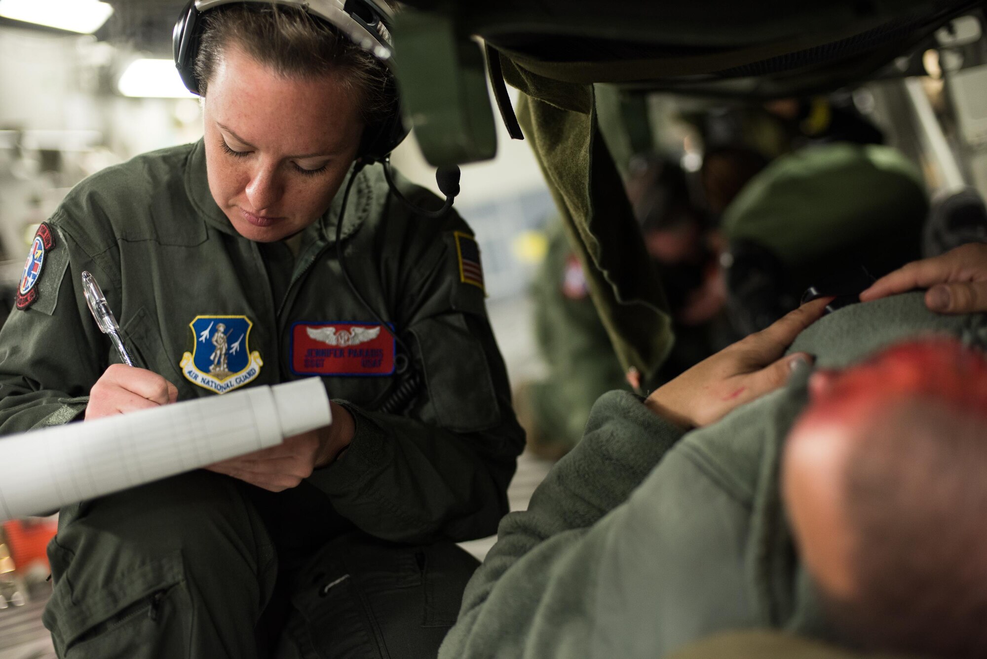 Staff Sgt. Jennifer Paradis, an aeromedical evacuation technician from the 137th Aeromedical Evacuation Squadron, Will Rogers Air National Guard Base, Oklahoma City, evaluates a simulated burn patient while transporting patients with burn moulage aboard a C-17 Globemaster III from the 105th Airlift Wing, Stewart Air National Guard Base, N.Y., en route to Altus Air Force Base, Altus, Okla., Oct. 30, 2017. The flight was part of a wildfire scenario during Vigilant Guard, a North American Command-sponsored, state-wide emergency response exercise held Oct. 30 to Nov. 2, 2017. (U.S. Air National Guard photo by Staff Sgt. Kasey M. Phipps)