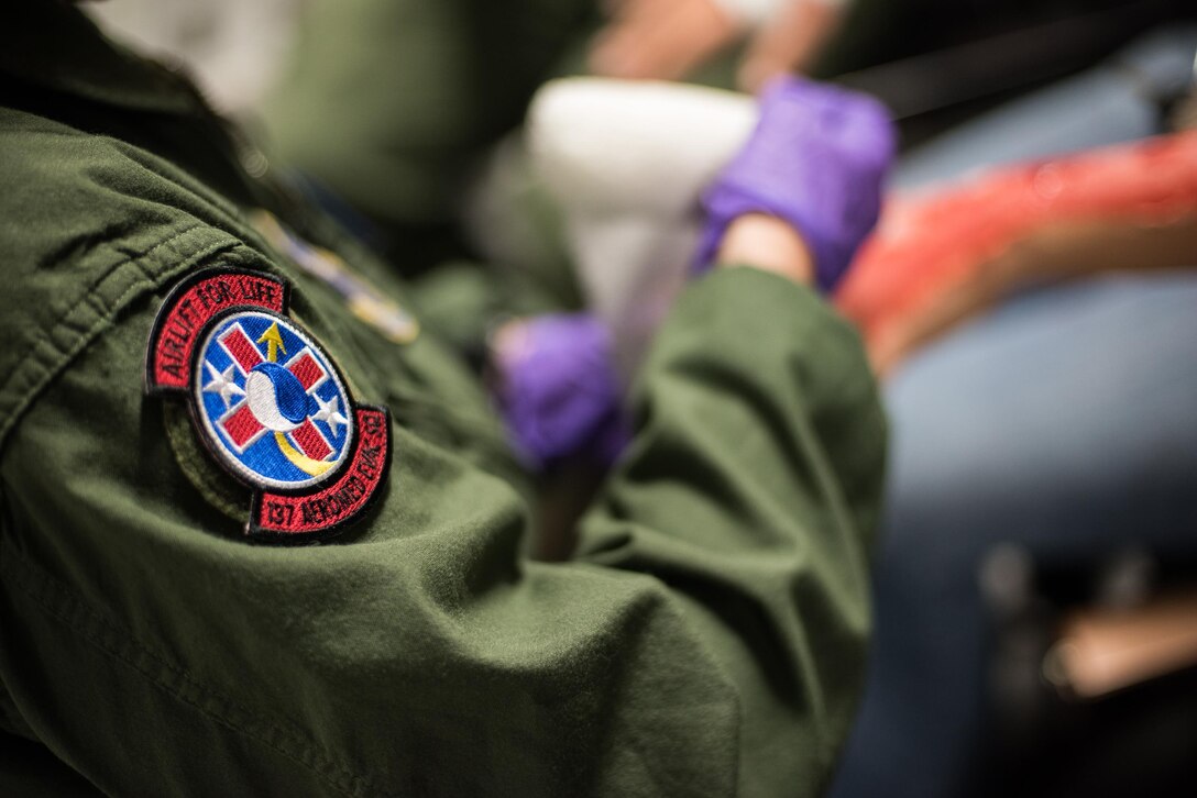 Staff Sgt. Sarah Bell, a medical technician from the 137th Aeromedical Evacuation Squadron, Will Rogers Air National Guard Base, Oklahoma City, loosely dresses the fingers, hand and arm of a simulated burn patient while transporting patients with burn moulage aboard a C-17 Globemaster III from the 105th Airlift Wing, Stewart Air National Guard Base, N.Y., en route to Altus Air Force Base, Altus, Okla., Oct. 30, 2017. The flight was part of a wildfire scenario during Vigilant Guard, a North American Command-sponsored, state-wide emergency response exercise held Oct. 30 to Nov. 2, 2017. (U.S. Air National Guard photo by Staff Sgt. Kasey M. Phipps)