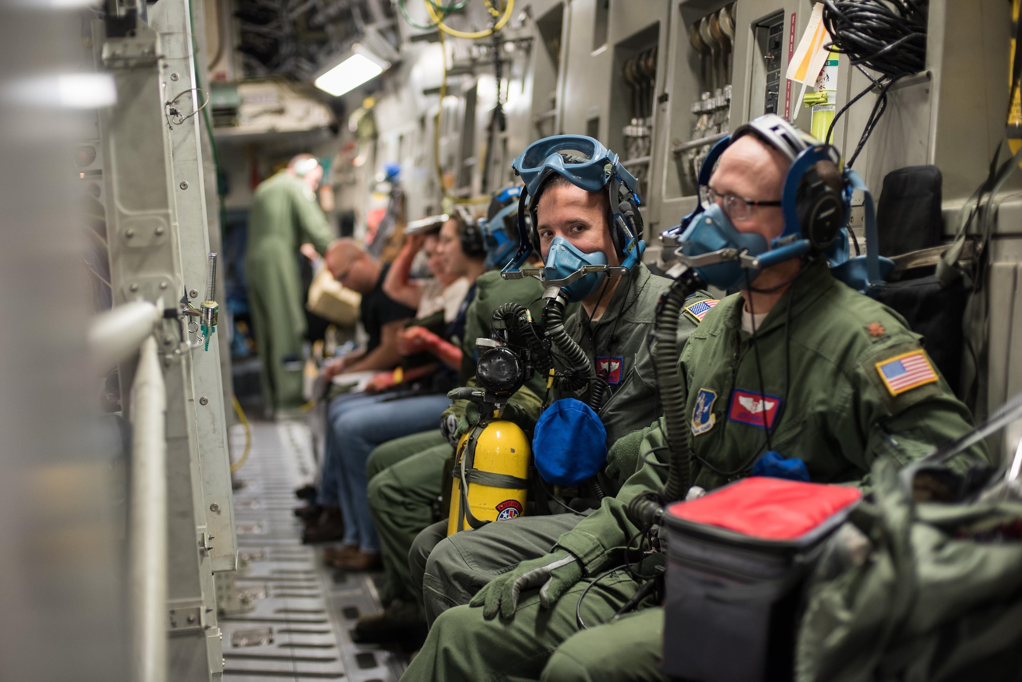 Capt. Sam Lingle (left), flight nurse, and Maj. Jeff Barley (right), medical crew director, both from the 137th Aeromedical Evacuation Squadron at Will Rogers Air National Guard Base, Oklahoma City, don oxygen masks during a simulated in-flight emergency while transporting patients aboard a C-17 Globemaster III from the 105th Airlift Wing, Steward Stewart Air National Guard Base, N.Y., en route to Altus Air Force Base, Altus, Okla., Oct. 30, 2017. The flight was part of a wildfire scenario during Vigilant Guard, a North American Command-sponsored, state-wide emergency response exercise held Oct. 30 to Nov. 2, 2017. (U.S. Air National Guard photo by Staff Sgt. Kasey M. Phipps)