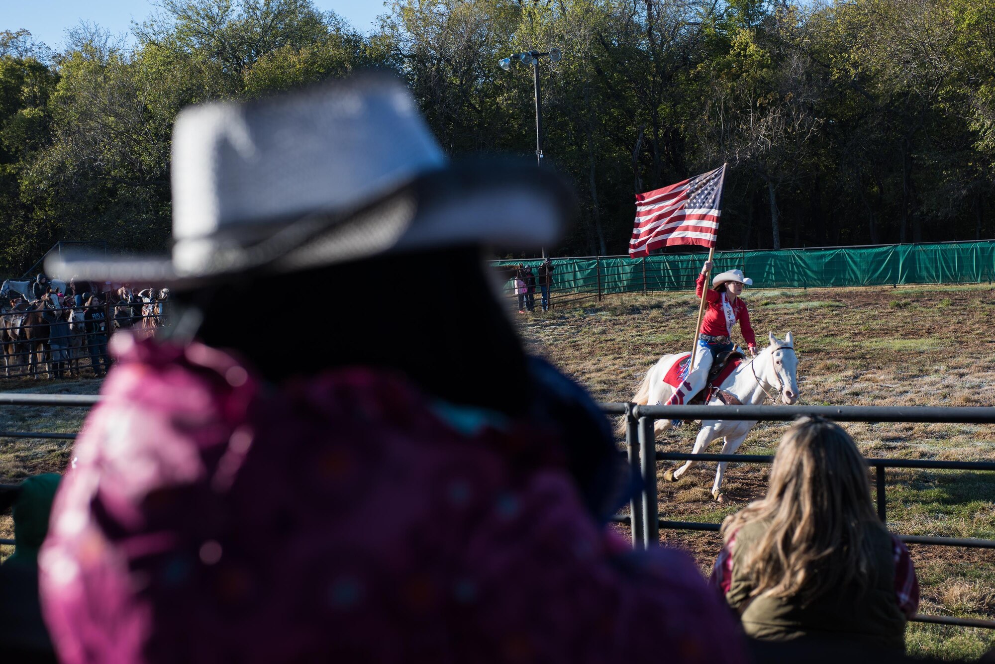Kate Gibson, 2017 89ers Day Rodeo Princess, presents the U.S. Flag during the National Anthem at the opening of the 6th Annual Oklahoma National Guard Adjutant General’s Horseback Heroes event, Oct. 28, 2017, at Covey Creek Ranch in Oklahoma City. Horseback Heroes is conducted each fall for military children to show support to the families of Guardsmen, especially those who are deployed. (U.S. Air National Guard photo by Staff Sgt. Kasey M. Phipps/Released)