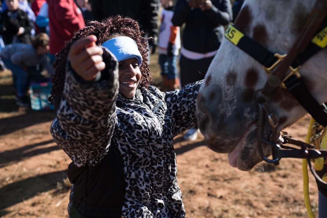 A child says goodbye to the horse she just rode before moving to her next activity at the 6th Annual Oklahoma National Guard Adjutant General’s Horseback Heroes event, Oct. 28, 2017, at Covey Creek Ranch in Oklahoma City. Horseback Heroes is conducted each fall for military children to show support to the families of Guardsmen, especially those who are deployed. (U.S. Air National Guard photo by Staff Sgt. Kasey M. Phipps/Released)