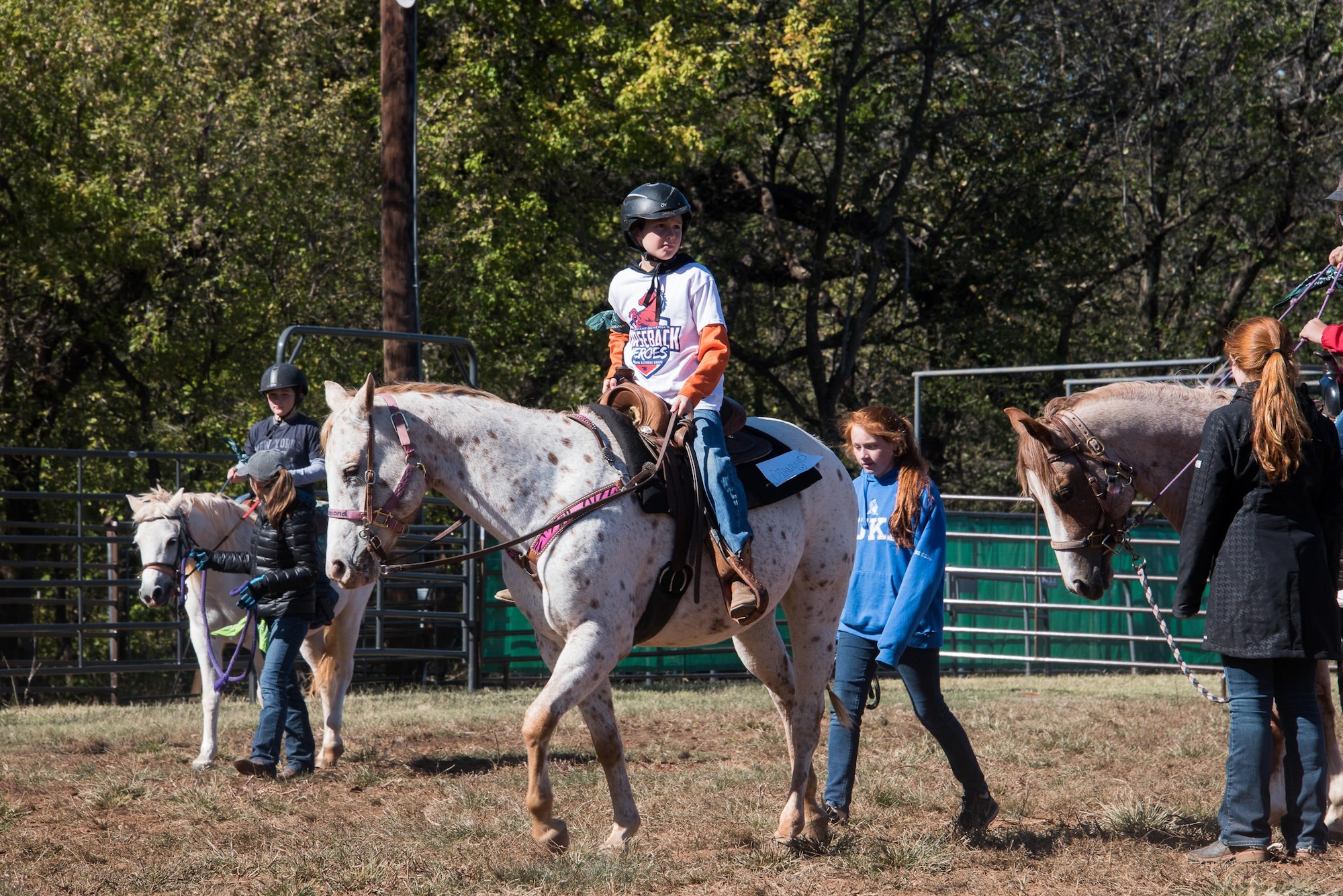 A child guides a horse around an arena during the 6th Annual Oklahoma National Guard Adjutant General’s Horseback Heroes event, Oct. 28, 2017, at Covey Creek Ranch in Oklahoma City. Horseback Heroes is conducted each fall for military children to show support to the families of Guardsmen, especially those who are deployed. (U.S. Air National Guard photo by Senior Airman Brigette Waltermire/Released)