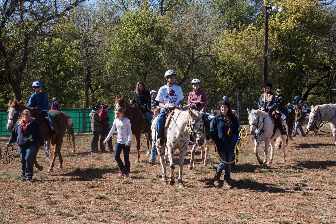 Children ride horses around the arena at Covey Creek Ranch in Oklahoma City during the 6th Annual Oklahoma National Guard Adjutant General’s Horseback Heroes event, Oct. 28, 2017. Horseback Heroes is conducted each fall for the children of Oklahoma National Guard service members, to show support to their families, especially those who are deployed. (U.S. Air National Guard photo by Senior Airman Brigette Waltermire/Released)