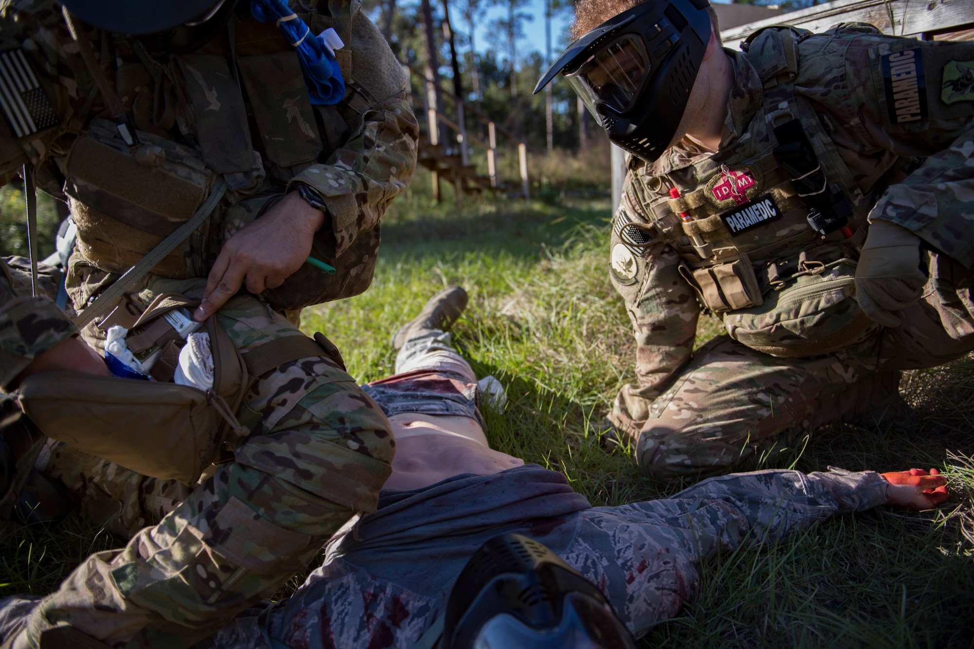 Staff Sgt. Cory Newby, 347th Operations Support Squadron Independent Duty Medical Technician paramedic observes a student applying Tactical Combat Causality Care during training, Oct. 25, 2017, at Moody Air Force Base, Ga. The new, three-day combined training is designed to merge many smaller courses and seamlessly tie together skills that could be used in the event that Airmen become isolated during a mission. (U.S. Air Force photo by Senior Airman Daniel Snider)