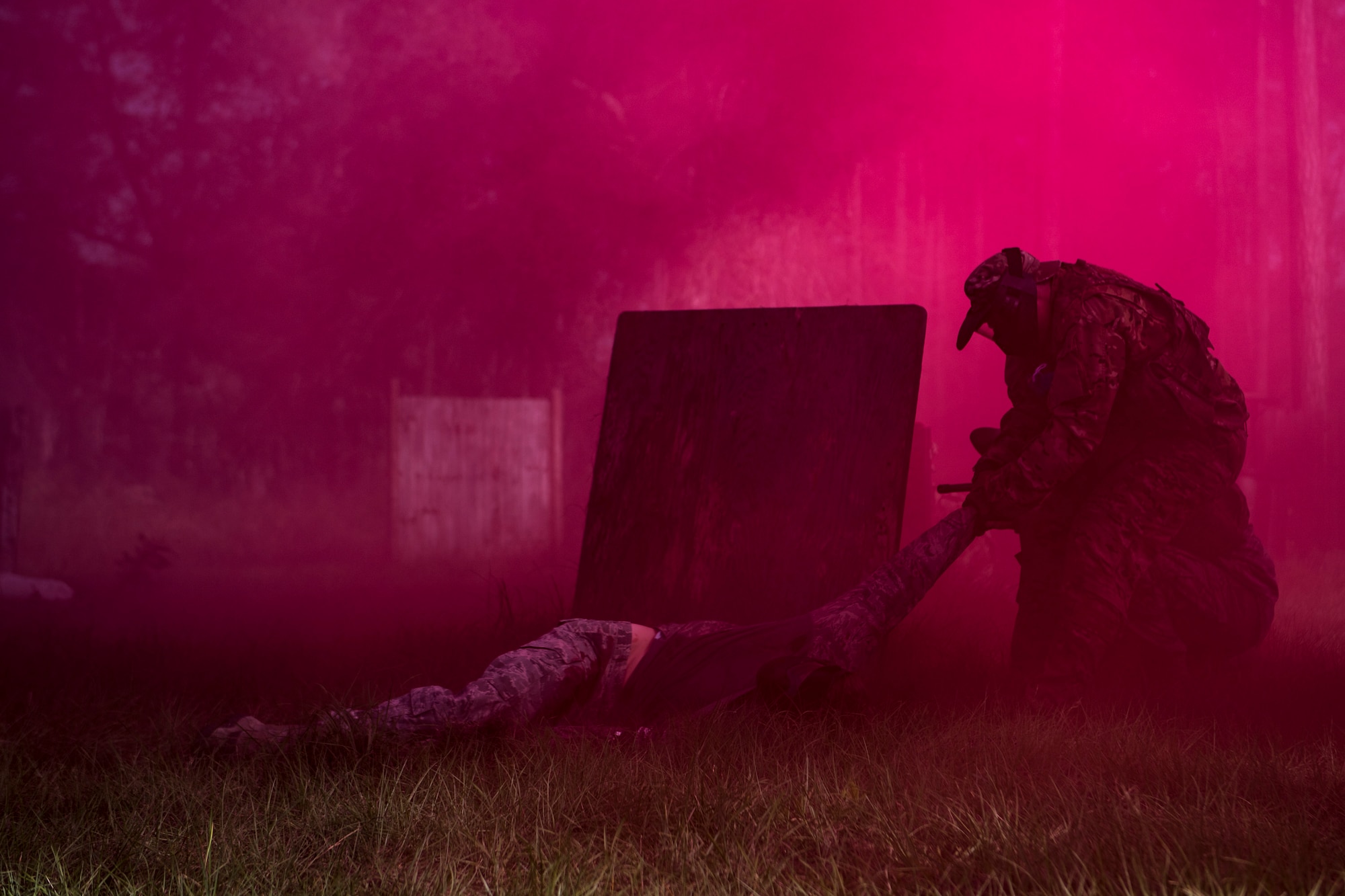 An Airman participating in a Tactical Combat Causality Care training scenario drags a teammate into cover during training, Oct. 25, 2017, at Moody Air Force Base, Ga. The new, three-day combined training is designed to merge many smaller courses and seamlessly tie together skills that could be used in the event that Airmen become isolated during a mission. (U.S. Air Force photo by Senior Airman Daniel Snider)