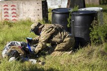 An Airman assigned to the 23d Wing applies a tourniquet during high-threat evasion and Tactical Combat Casualty Care training, Oct. 25, 2017, at Moody Air Force Base, Ga. The new, three-day combined training is designed to merge many smaller courses that seamlessly tie together skills that could be used in the event that Airmen become isolated during a mission. (U.S. Air Force photo by Airman Eugene Oliver)