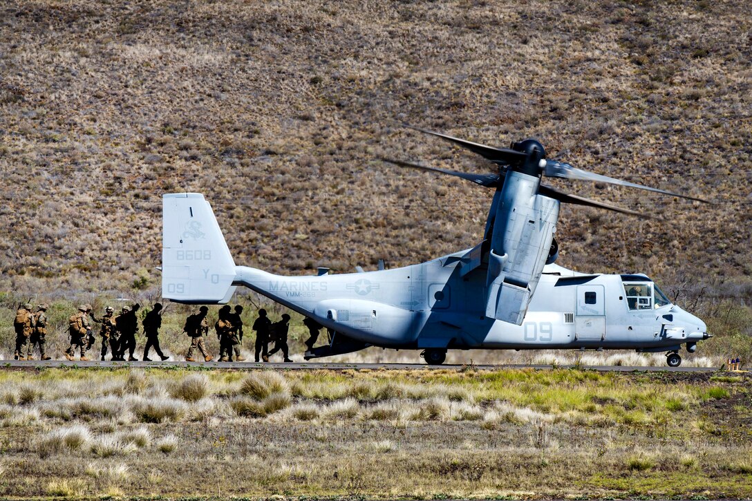 Marines load onto an MV-22 Osprey aircraft after participating in a tactical recovery of aircraft and personnel training event.