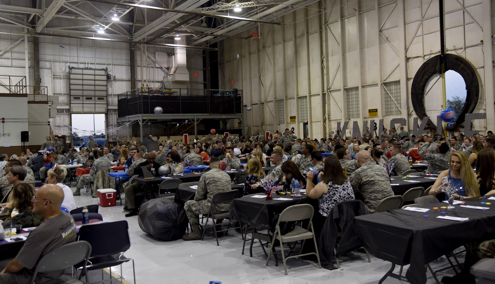 Banquet attendees throw beach balls, toy airplanes and flying disks through the air at the Knucklebusters banquet Oct. 14, 2017, at McConnell Air Force Base, Kansas. The banquet is meant to recognize Airmen at all levels for the work they do throughout the year. (U.S. Air Force photo by Airman 1st Class Erin McClellan)