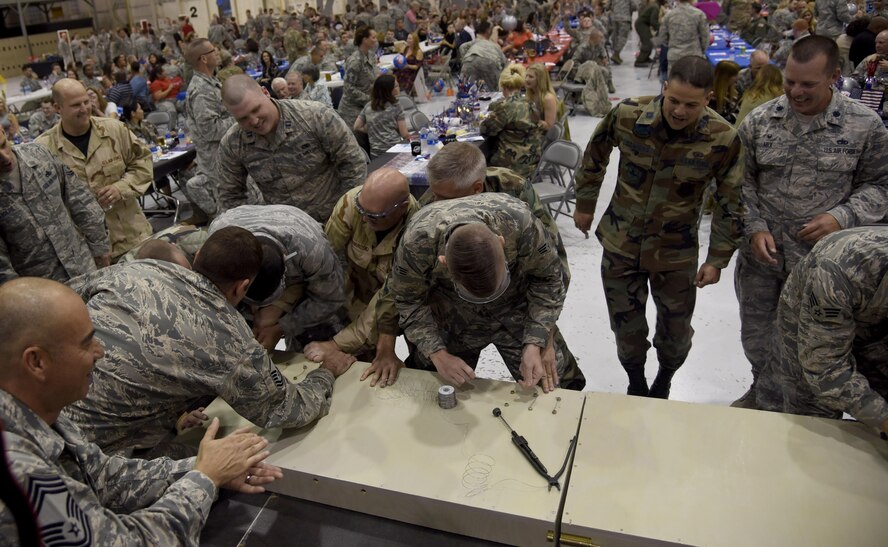 Members of each squadron within the 22nd Maintenance Group race to complete a safety wiring challenge to decide which squadron will be first in line to eat at the Knucklebusters banquet Oct. 14, 2017, at McConnell Air Force Base, Kansas. Although not the first to host the event, McConnell has hosted the most Knucklebuster ceremonies consecutively out of the entire Air Force. (U.S. Air Force photo by Airman 1st Class Erin McClellan)