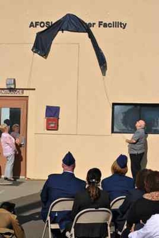 Parents of AFOSI Fallen SA David Wieger unveil the sign naming the AFOSI Det. 303 building in their son's honor.