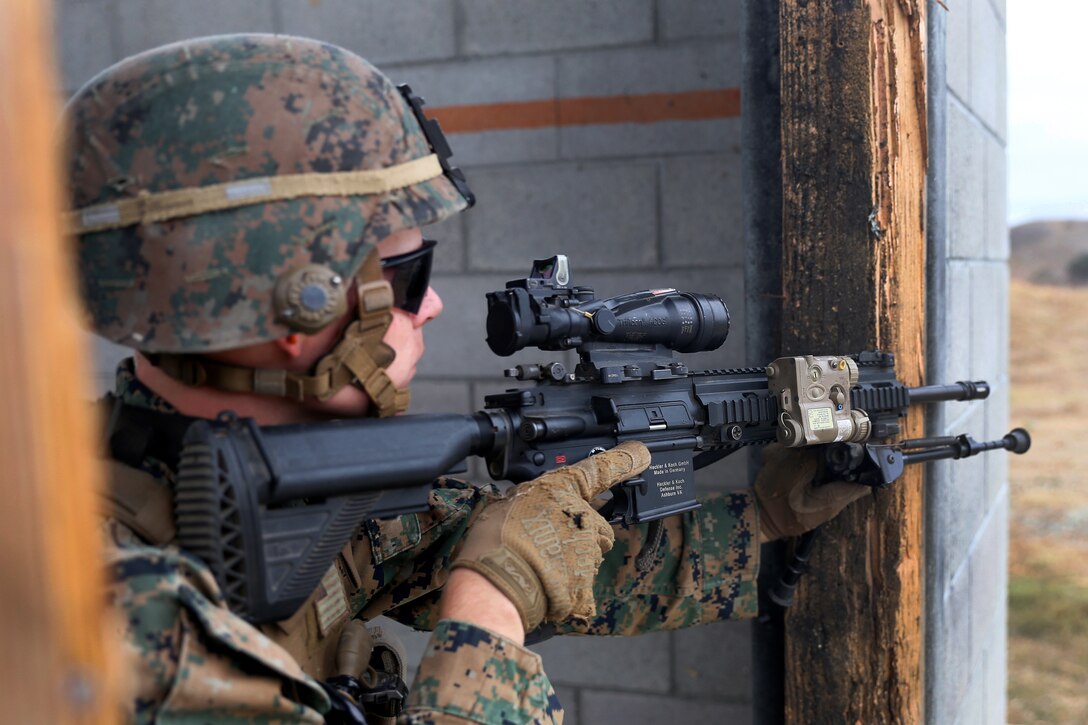 A Marine holds a gun during a training exercise.