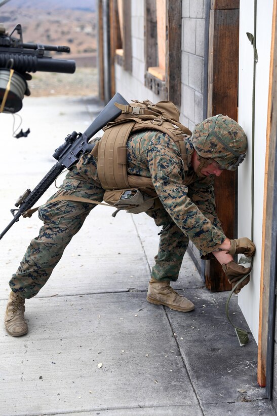 A Marine places an explosive charge.
