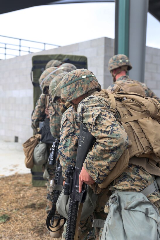 Marines move in single file toward an objective.