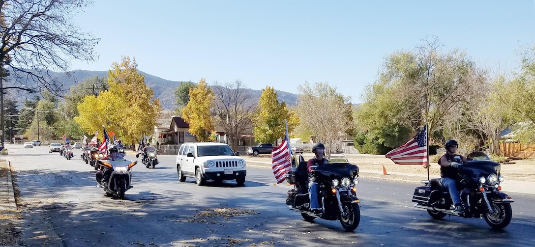 Patriot Guard Riders escort Capt. Bob Wood, a WWII B-17 pilot, to Tehachapi Airport, for a visit to an aircraft restoration hangar during an event honoring Wood's service. (U.S. Air Force photo by Steve Zapka)