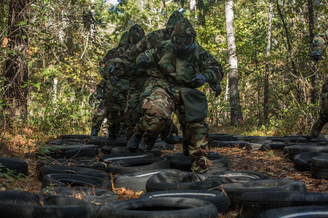 U.S. Marines with the 26th Marine Expeditionary Unit (MEU), run through an obstacle course wearing full Mission Oriented Protective Posture during a chemical, biological, radiological, nuclear training event at Camp Lejeune, N.C., Oct. 30, 2017.