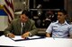 Daniel Valenzuela, San Angelo city manager, and U.S. Air Force Col. Ricky Mills, 17th Training Wing commander, sign a memorandum of agreement in Goodfellow’s firetruck maintenance facility on Goodfellow Air Force Base, Texas, Oct. 31, 2017. The MOA between the base and city is a reaffirmation for Goodfellow to perform maintenance on the city’s firetrucks. (U.S. Air Force photo by Senior Airman Scott Jackson/Released)