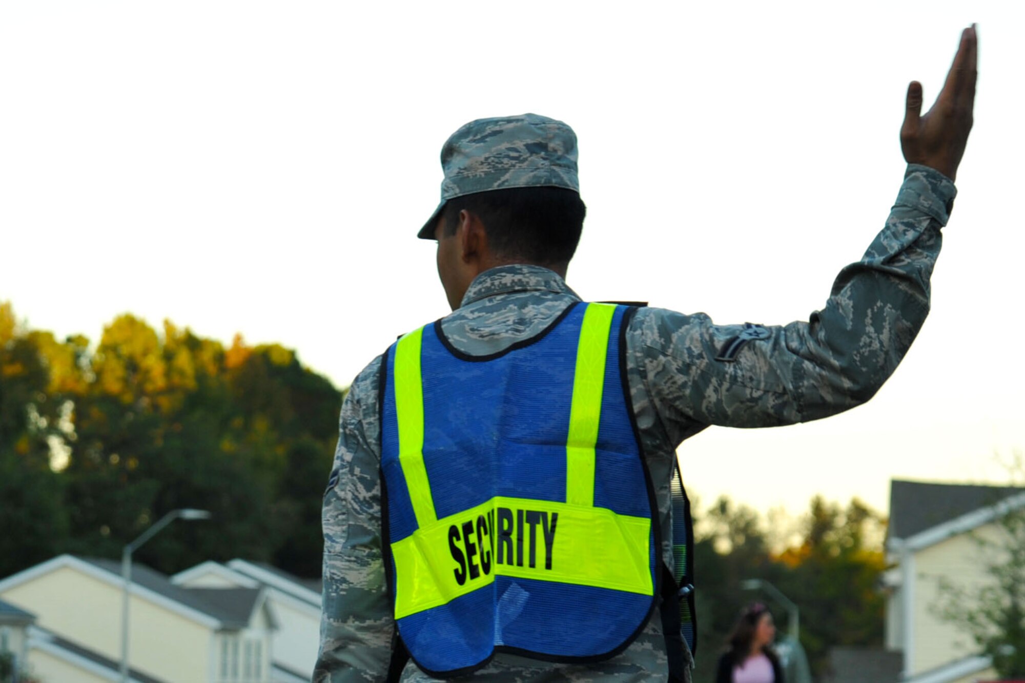 U.S. Air Force Airman 1st Class Emanuel Castro, 20th Logistics Readiness Squadron individual protective equipment apprentice and Pumpkin Patrol volunteer, directs traffic at Shaw Air Force Base, South Carolina, Oct. 31, 2017.